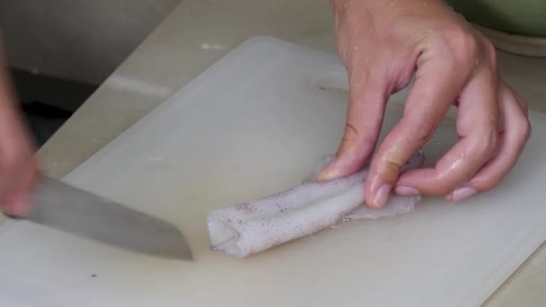 Vrouw hand snijdt en schoon verse octopus — Stockvideo