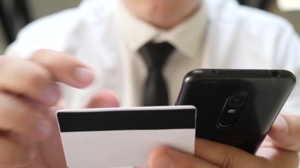 Jonge volwassen man met creditcard met behulp van smartphone online winkelen — Stockvideo