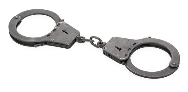 Пара замкнутых металлических наручников, изолированных на белой спине — стоковое фото