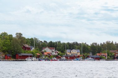 Charming Swedish houses along Stockholm fjord coast. Idyllic Nordic summer travel destination, perfect for vacation, relaxation, and exploring Scandinavian lifestyle