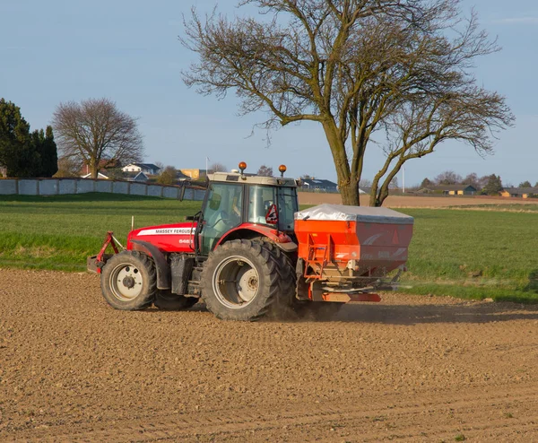 Farmer on a massey Ferguson tractor spreading fertilizer — Stock Photo, Image