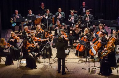 DNIPRO, UKRAINE - DECBER 17, 2018: FOUR SEASONS Chamber Orchestra - main conductor Dmitry Logvin perform  at the State Drama Theatre. clipart