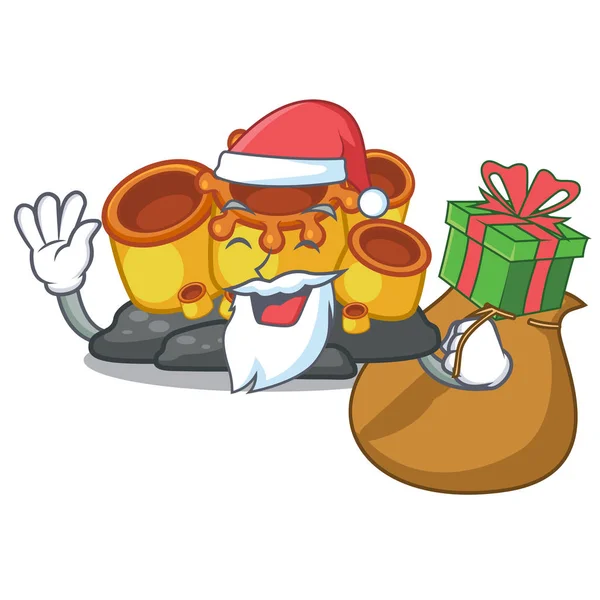 Mascotte de Santa avec cadeau éponge orange corail en forme — Image vectorielle