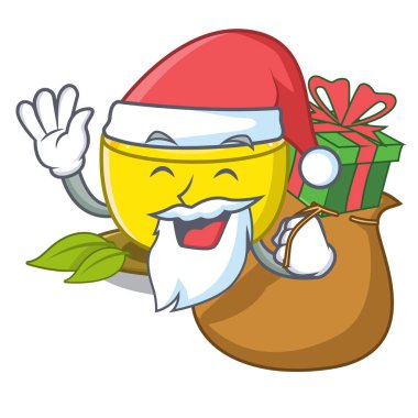 Maskot ahşap masa üzerinde hediye zerdeçal çayı ile Santa