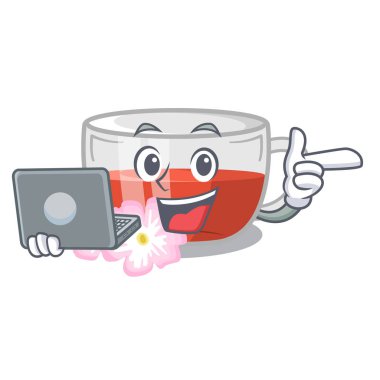 Ahşap maskot masa üzerinde dizüstü kuşburnu çayı ile