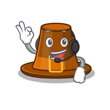 Çizgi film masasında kulaklık takan hacı şapkasıyla.