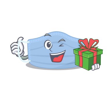 Büyük bir hediye kutusu olan neşeli cerrahi maske karakteri.