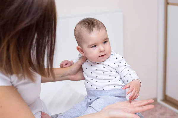 Young mother is playing with her happy baby — Stock Photo, Image