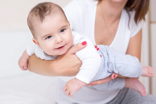 Young mother is playing with her happy baby — Stock Photo, Image