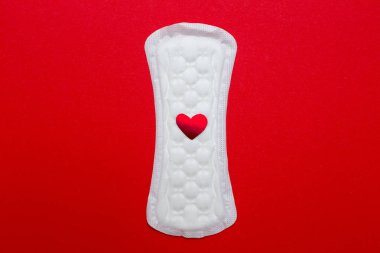 menstruasyon kavramı. bir adet yastık üzerinde kırmızı bir arka plan görüntüsünü