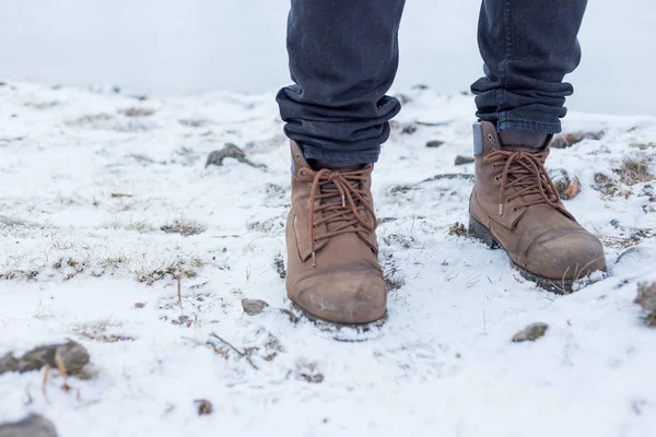 a pair of hiker trekking boots in a winter forest
