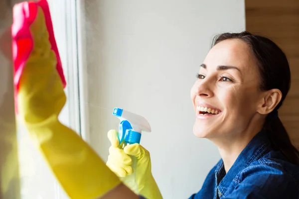 Hermosa Mujer Joven Usando Plumero Aerosol Mientras Limpia Ventanas Casa — Foto de Stock