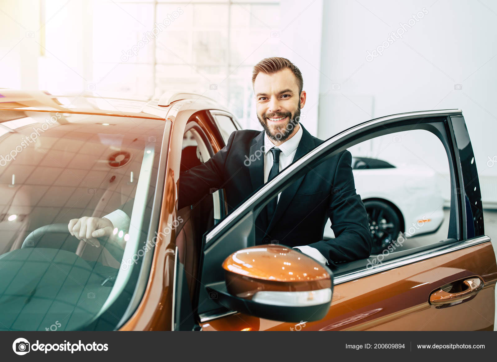 Confident Man Holding Car Wheel Standing Open Car Door Dealership