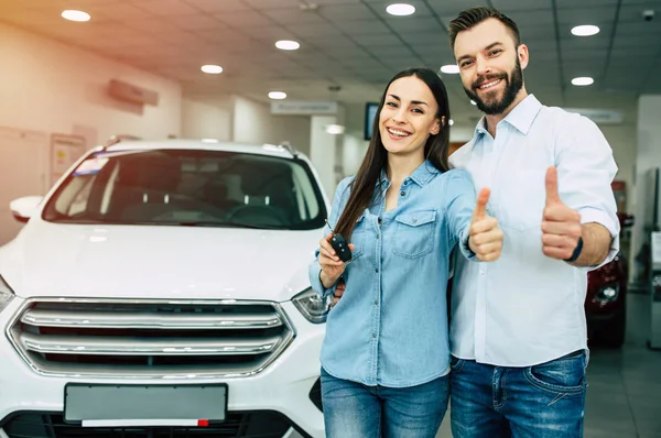 Happy Young Couple Casual Wear Standing New Car Dealership Showing — Stock Photo, Image