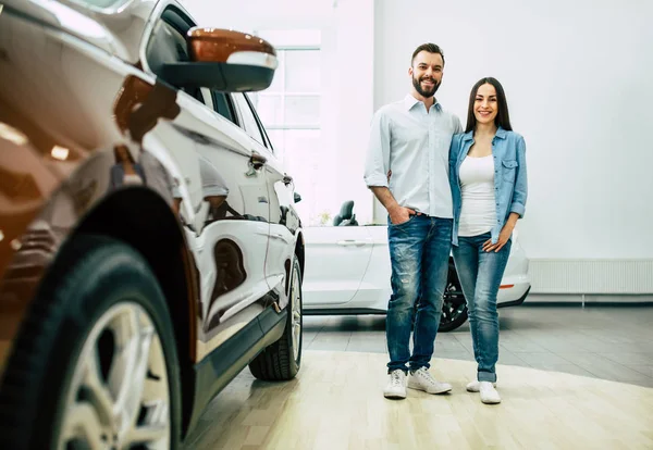 Happy Young Hugging Couple Casual Wear Standing New Car Dealership — Stock Photo, Image