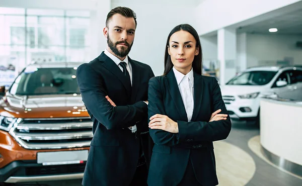 Smiling Business Couple Suits Standing Crossed Arms Looking Camera Dealership — Stock Photo, Image