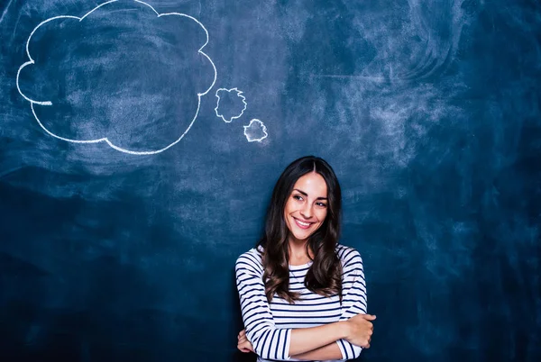 Young brunette woman with speech bubble on chalkboard