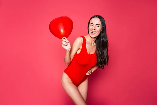 Jonge Brunette Vrouw Rode Zwembroek Poseren Met Ballon Roze Achtergrond — Stockfoto