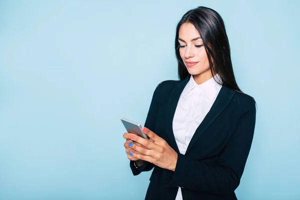 Portrait of businesswoman texting message using smartphone