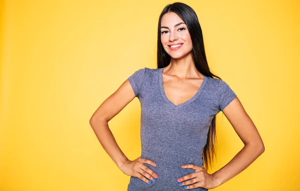 Mujer Joven Sonriendo Tomándose Mano Cintura Sobre Fondo Amarillo — Foto de Stock