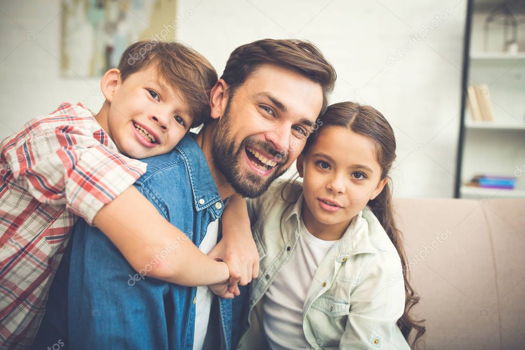 Young father spending time with children at home