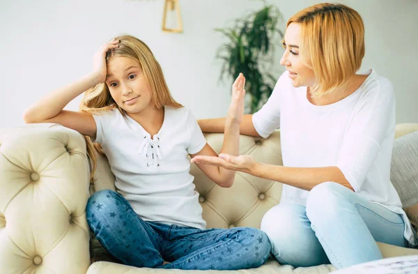 Mother trying to talk with her teen daughter