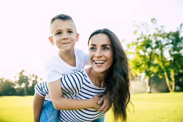 Happy Beautiful Young Mother Playing Her Little Son While Riding — Stock Photo, Image