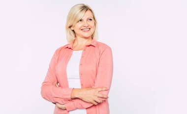 Stüdyoda izole mutlu gülümseyen ve güzel sarışın yaşlı kadın yakın portre ve kamera gülümseme ile poz