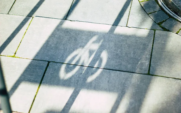 Bike parking stand shadow. A close up photo of a bike parking stand shadow on the street tile.