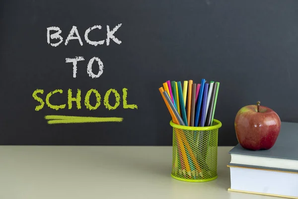 Okula dönüş sağlar. Kitap ve koyu arka plan üzerinde kırmızı elma. Natürmort. Kopya alanı.