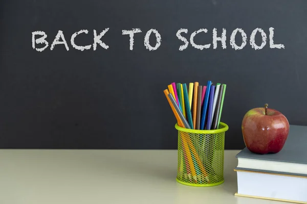 Okula dönüş sağlar. Kitap ve koyu arka plan üzerinde kırmızı elma. Natürmort. Kopya alanı.