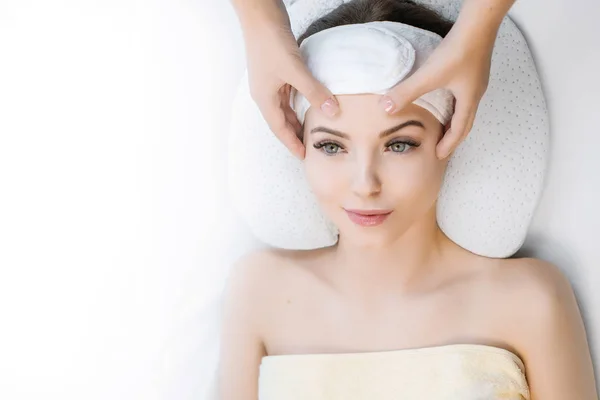 Close up view of cosmetologist making face massage