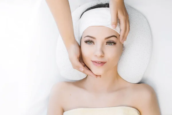 Close up view of cosmetologist making face massage