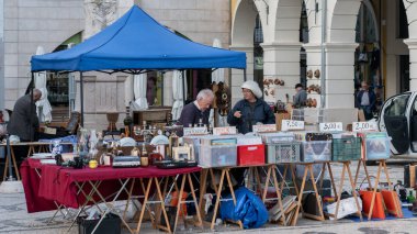 Aveiro, Portugal - April 2018: Couple selling retro record and items at monthly street flea market in Aveiro, Portugal clipart