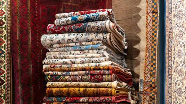 Montón de alfombras y alfombras tradicionales iraníes en una tienda de alfombras, Isfihan, Irán — Foto de Stock