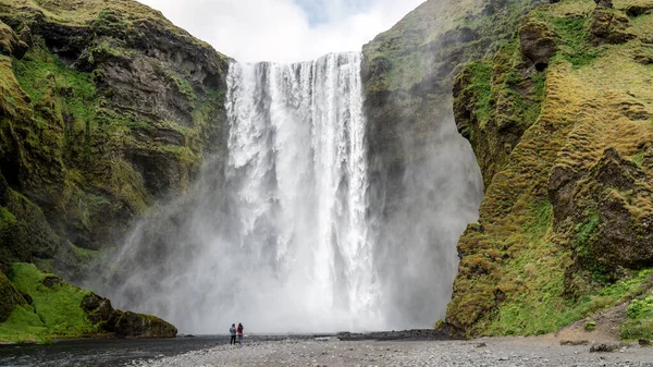 Ogromny wodospad Skogafoss z parą fotografów, Skogar, na południe od Islandii — Zdjęcie stockowe