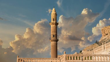Mardin, Turkey - January 2020: Minaret of Ulu Cami, also known as Great mosque of Mardin with dramatic sky clipart