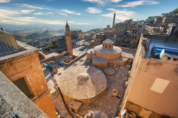 Mardin, Turkey - January 2020: Old city of Mardin cityscape with roof of Turkish hammam and minarets