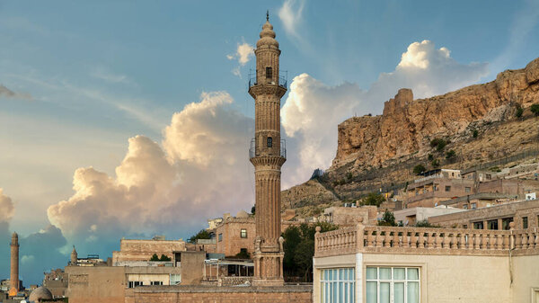 Mardin, Turkey - January 2020: Minaret of Ulu Cami, also known as Great mosque of Mardin with old town mardin cityscape. Suitable for copy space