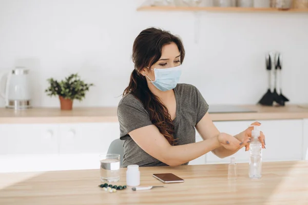 COVID-19 Young woman using wash hand sanitizer gel dispenser, against Novel coronavirus (2019-nCoV) at home. Home isolation, Auto Quarantine, Antiseptic, Hygiene and Healthcare concept.