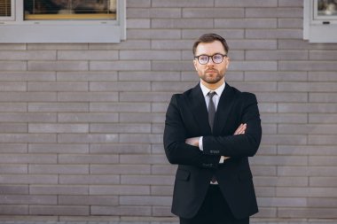 Portrait of a confident businessman standing with arms crossed, exuding professionalism and success