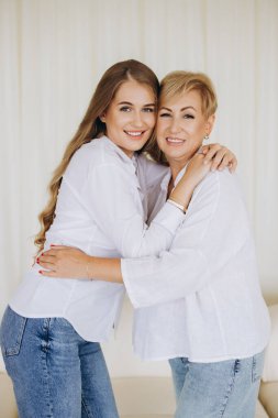 Happy mother and daughter embracing each other, radiating love and joy while sharing a beautiful moment of connection and togetherness