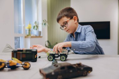 Child enjoying his playtime with building blocks, developing creativity and problem solving skills in a comfortable home environment