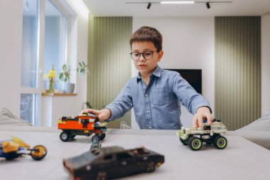 Child enjoying his playtime with building blocks, developing creativity and imagination in a comfortable home environment