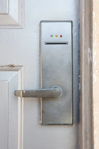 Modern metal door handle with security system lock