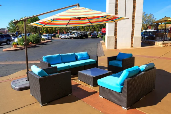 cafe Black and Blue Artificial rattan chair and table outdoor with big colorful umbrella