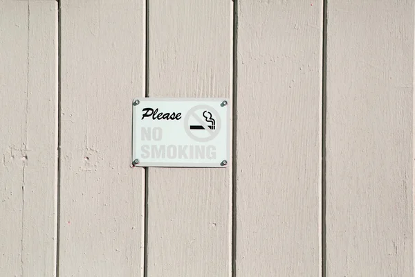 No smoking sign on beige wood wall