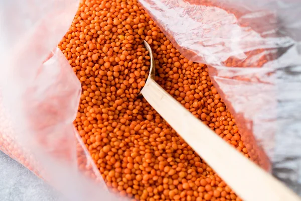 Dry Red Lentils in Wooden Spoon Cereal / Masoor Dal. Organic Product.