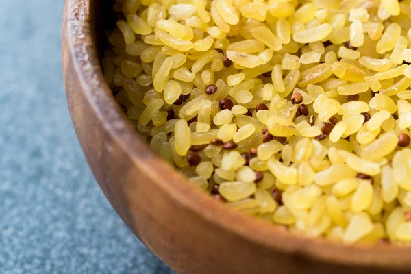 Uncooked Raw Bulgur Rice with Quinoa in Wooden Bowl. / Bulghur for Pilav or Pilaf. Organic Food.