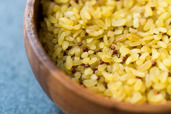 Uncooked Raw Bulgur Rice with Quinoa in Wooden Bowl. / Bulghur for Pilav or Pilaf. Organic Food.